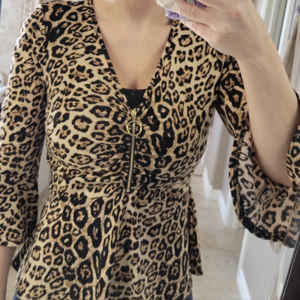 Bell sleeve peplum top in leopard